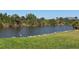 Scenic view of waterfront home with lush green grass and clear water views with wild life at 9158 Melody Cir, Port Charlotte, FL 33981
