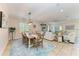 Open concept dining area with a wooden table, seating for six, and a stylish light fixture at 9283 Newnan Cir, Port Charlotte, FL 33981