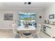 Dining area with view through sliding doors to outdoor entertainment and pool at 9283 Newnan Cir, Port Charlotte, FL 33981