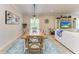 Dining room with wood table, pendant lighting, and view of the living space with decorative accents at 9283 Newnan Cir, Port Charlotte, FL 33981