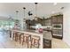 Kitchen featuring a granite countertop island with seating, pendant lighting, and dark cabinetry at 9283 Newnan Cir, Port Charlotte, FL 33981