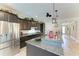 Spacious kitchen boasting granite countertops, dark cabinets, and stainless steel appliances at 9283 Newnan Cir, Port Charlotte, FL 33981