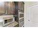 A close-up view of built-in stainless steel oven and microwave appliances in the kitchen at 9283 Newnan Cir, Port Charlotte, FL 33981