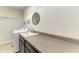 Laundry room featuring a sink with storage, counterspace and modern washer and dryer at 9283 Newnan Cir, Port Charlotte, FL 33981