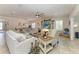 Bright living room featuring tile floors, a ceiling fan, and comfortable seating around a flat-screen TV at 9283 Newnan Cir, Port Charlotte, FL 33981