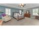 Spacious main bedroom showcasing tray ceiling, generous windows, and a cozy seating area at 9283 Newnan Cir, Port Charlotte, FL 33981