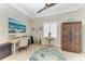 Bright office with desk, cabinetry, plantation shutters, and decorative ceiling fan at 9283 Newnan Cir, Port Charlotte, FL 33981