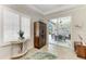 Office space featuring an armoire, sliding glass doors to the lanai, and plantation shutters at 9283 Newnan Cir, Port Charlotte, FL 33981