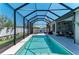 Relaxing screened pool with sunny seating area, patio, and privacy landscaping at 9283 Newnan Cir, Port Charlotte, FL 33981