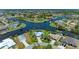 Stunning aerial view of waterfront homes along winding canals, lush greenery, and beautiful landscaping at 9404 Arnaz Cir, Port Charlotte, FL 33981