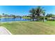 Expansive backyard with tropical landscaping and picturesque water views at 9404 Arnaz Cir, Port Charlotte, FL 33981