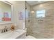 Bathroom featuring a modern tiled shower with glass door and a white vanity with marble countertop at 9404 Arnaz Cir, Port Charlotte, FL 33981