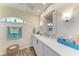 Bathroom featuring a granite vanity, modern fixtures, and stylish decor at 9404 Arnaz Cir, Port Charlotte, FL 33981