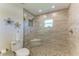 Modern bathroom shower featuring elegant tilework, frameless glass and a built-in bench at 9404 Arnaz Cir, Port Charlotte, FL 33981