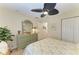 Bedroom featuring coastal decor, a ceiling fan, and a light green dresser with matching mirror at 9404 Arnaz Cir, Port Charlotte, FL 33981