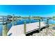 New wooden dock with sturdy pilings and scenic waterfront views on a sunny day at 9404 Arnaz Cir, Port Charlotte, FL 33981