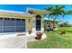 Welcoming front entrance with potted flowers, decorative accents, and a well-maintained garden at 9404 Arnaz Cir, Port Charlotte, FL 33981