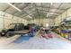 Spacious garage interior featuring high ceilings, organized storage, a truck, and an off-road vehicle at 9404 Arnaz Cir, Port Charlotte, FL 33981