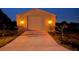 The new garage has a concrete drive and attractive lighting at 9404 Arnaz Cir, Port Charlotte, FL 33981