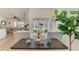 Bright living room with view to outdoor pool through sliding glass doors at 9404 Arnaz Cir, Port Charlotte, FL 33981