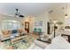 Open concept living room featuring stylish decor, comfortable seating, and ample natural light at 9404 Arnaz Cir, Port Charlotte, FL 33981