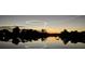 Enjoy the sunset reflecting over the water in this quiet waterfront community at 9404 Arnaz Cir, Port Charlotte, FL 33981