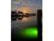 Stunning waterfront scene at dusk featuring tranquil water, cloud reflections, and distant homes at 9404 Arnaz Cir, Port Charlotte, FL 33981