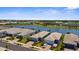 Picturesque aerial view showcasing a vibrant community with lake access, a clubhouse, and immaculate landscaping at 9853 Bright Water Dr, Englewood, FL 34223