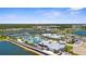 Beautiful aerial view of a community featuring lakes, a pool, tennis courts and lovely landscaping at 9853 Bright Water Dr, Englewood, FL 34223
