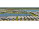 Stunning aerial view of single-Gathering homes, community pool and amenity center overlooking a serene lake at 9853 Bright Water Dr, Englewood, FL 34223