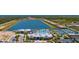 Wide aerial shot of community amenities including lakes, tennis courts, and a resort-style pool area at 9853 Bright Water Dr, Englewood, FL 34223