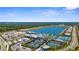Aerial view showcasing a resort-style pool, tennis courts, and other community amenities by the lake at 9853 Bright Water Dr, Englewood, FL 34223