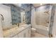 Bathroom features a luxurious soaking tub and shower with stylish blue wallpaper at 9853 Bright Water Dr, Englewood, FL 34223