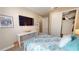 Comfortable bedroom featuring a bed, desk, TV, and closet for storage and relaxation at 9853 Bright Water Dr, Englewood, FL 34223