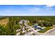 Scenic community entrance featuring palm trees, lush landscaping, and charming blue gatehouses at 9853 Bright Water Dr, Englewood, FL 34223