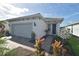 Charming home exterior with well-manicured landscaping and inviting walkway at 9853 Bright Water Dr, Englewood, FL 34223