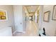 Entry hallway featuring neutral paint and tile, and decorated with framed art at 9853 Bright Water Dr, Englewood, FL 34223