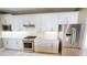 Well-equipped kitchen showcasing stainless steel appliances and sleek white cabinetry at 9853 Bright Water Dr, Englewood, FL 34223