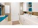The laundry room features modern washer and dryer with custom storage and blue countertops at 9853 Bright Water Dr, Englewood, FL 34223