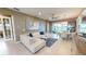 Bright living room with comfortable seating, a dining area, and a view of the water at 9853 Bright Water Dr, Englewood, FL 34223