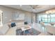 Bright living room featuring a white leather sectional sofa, modern art, and sliding glass doors to the lanai at 9853 Bright Water Dr, Englewood, FL 34223
