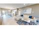 Open-concept living room with a comfortable sofa and a view of the modern kitchen at 9853 Bright Water Dr, Englewood, FL 34223
