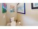 Neat powder room featuring a toilet, toilet-paper holder, and framed artwork on the wall at 9853 Bright Water Dr, Englewood, FL 34223