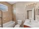 Bathroom featuring a shower-tub combo, toilet, and vanity with a large well lit mirror at 10495 Atenia St, Port Charlotte, FL 33981