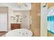 Bathroom showcasing a soaking tub and shower, complemented by modern fixtures and finishes at 10495 Atenia St, Port Charlotte, FL 33981