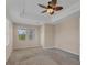 Spacious bedroom with scenic views from multiple windows and a decorative ceiling fan at 10495 Atenia St, Port Charlotte, FL 33981