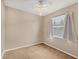 Cozy bedroom with neutral walls, ceiling fan, plush carpet, and natural light streaming in at 10495 Atenia St, Port Charlotte, FL 33981