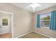 Small bedroom with neutral walls, carpeting, and a window allowing natural light at 10495 Atenia St, Port Charlotte, FL 33981