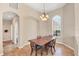 Bright dining area with tile flooring, a modern chandelier, and a large window for natural light at 10495 Atenia St, Port Charlotte, FL 33981