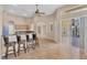 Open kitchen featuring a breakfast bar with granite countertops and modern ceiling fan at 10495 Atenia St, Port Charlotte, FL 33981